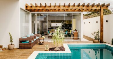 brown wooden table near swimming pool