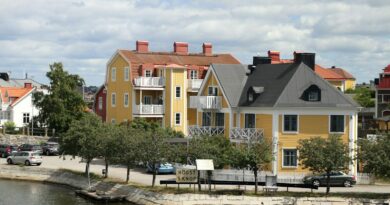 A row of houses next to a body of water
