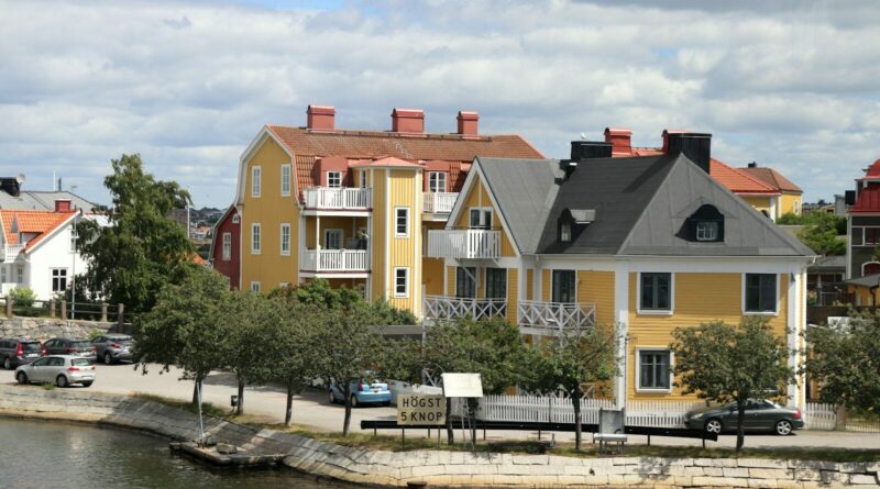 A row of houses next to a body of water