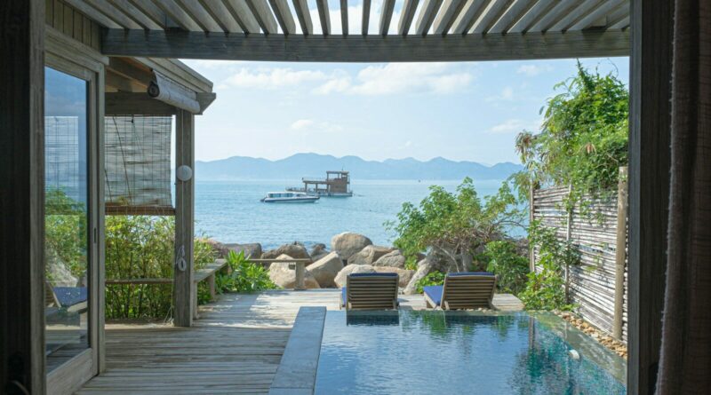 brown wooden chairs near swimming pool during daytime